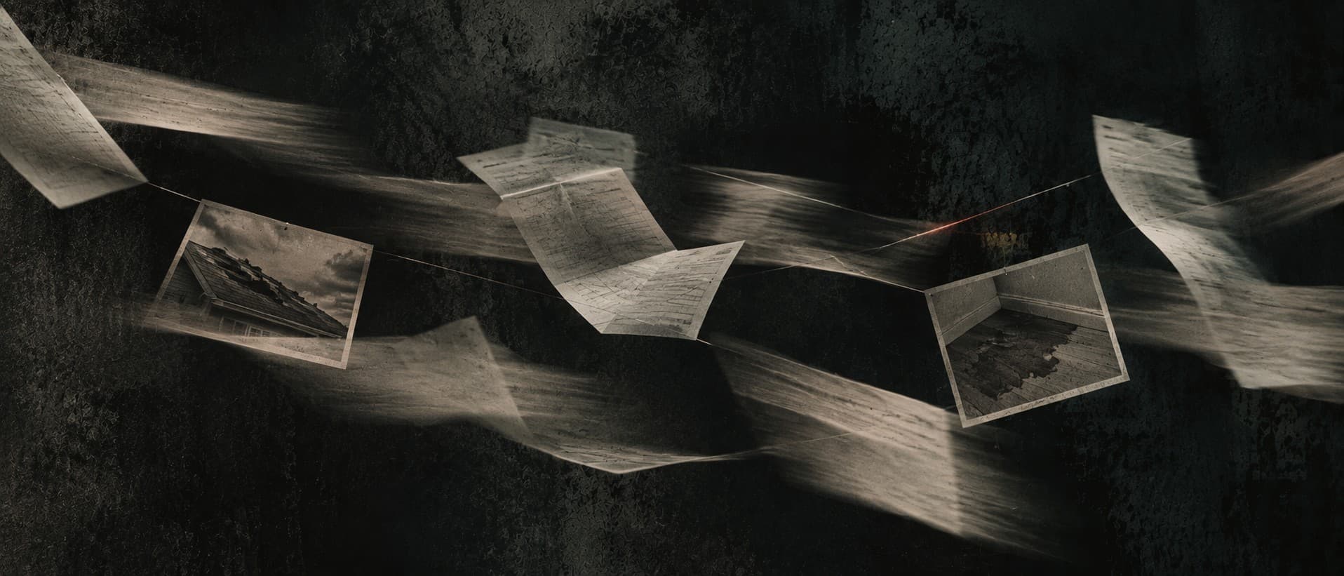 Claim records and damage photographs connected by fine threads in a dark room